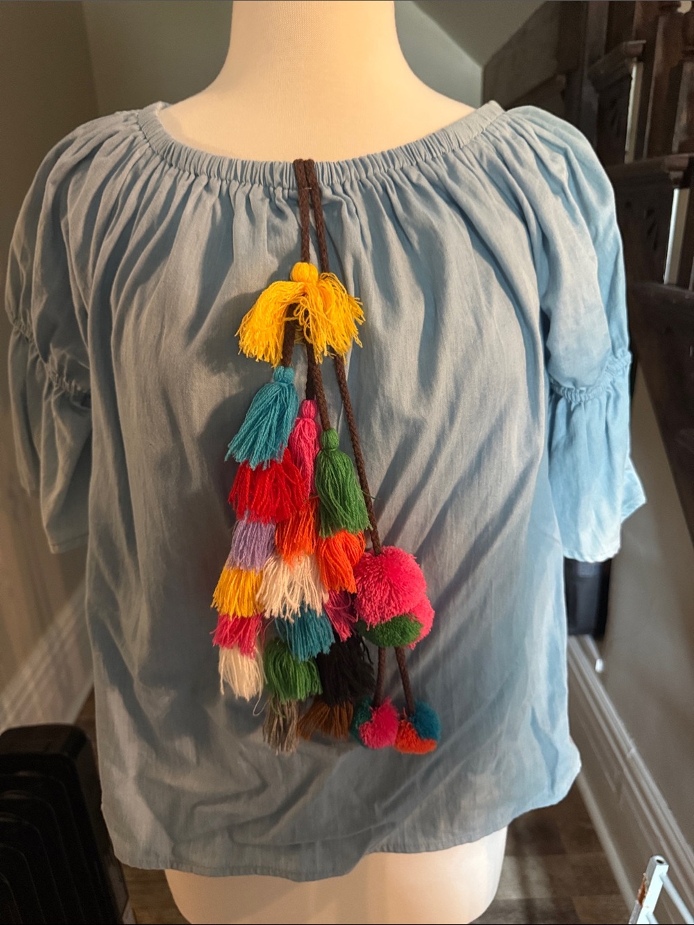 Ballon sleeve denim top with colorful tassel accent